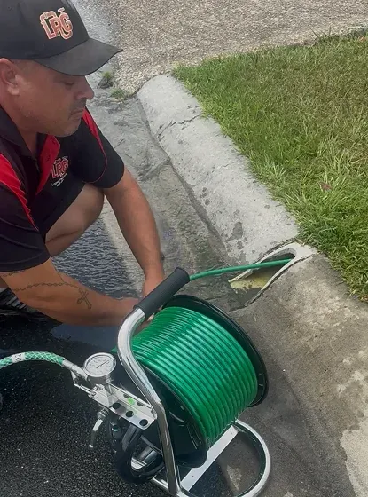 Plumber clearing a blocked drain with a drain jetter in Logan