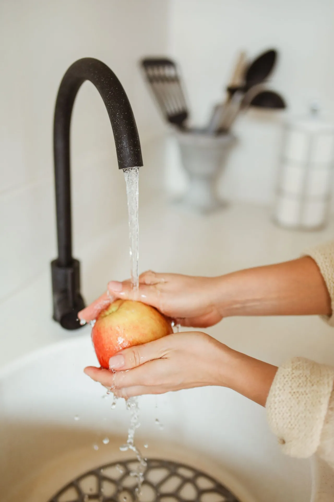 Washing fruit under clean, filtered tap water